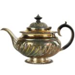 A George IV silver half wrythen fluted teapot by Jonathan Hayne.