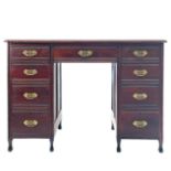 An Arts and Crafts mahogany fixed pedestal desk.