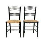 A pair of Arts and Crafts ebonised faux bamboo chairs.