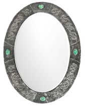An Arts and Crafts oval pewter mirror.