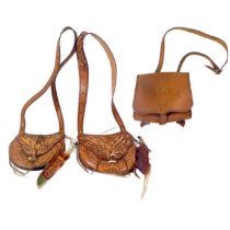 A handmade leather bag with tooled detail.