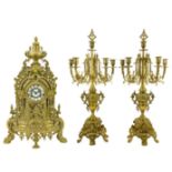 An ornate Continental brass clock garniture.