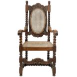 A Victorian walnut caned armchair.