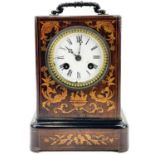 A French rosewood and inlaid mantel clock.