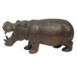 A large Brown painted hardwood figure of a Hippo.