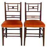 A pair of Aesthetic movement walnut chairs.