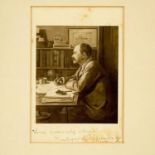 A portrait of Rudyard Kipling with inscription.