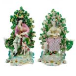 A pair of Derby porcelain bocage candlestick figures.