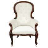 A Victorian mahogany framed button backed upholstered slipper armchair.