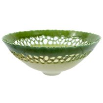 A footed Peter Lane pierced porcelain bowl, with a green glazed rim fading into a matt white body,