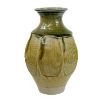 A cut-sided Jonathan Chiswell-Jones stoneware vase, circa 1990, with a running green glaze,