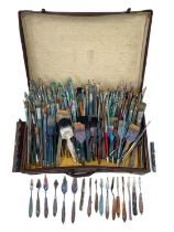 A suitcase containing a collection of John Miller's paintbrushes and palette knives. Width 64cm,