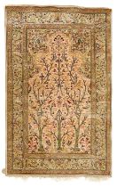 A Persian silk rug.