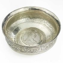 An Indian silver bowl inset with a Marie Theresa Thaler coin.