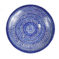 A Moroccan pottery blue and white charger, early 20th century.