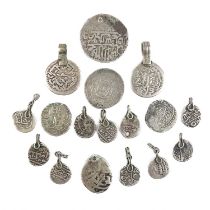 A collection of seventeen Indian silver coins.