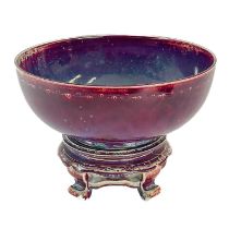 A Ruskin high-fired bowl, sang de boeuf glaze with incised border.