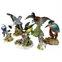 A collection of six hand painted ceramic birds.