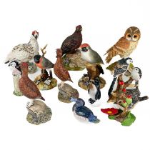 A collection of hand painted ceramic birds.