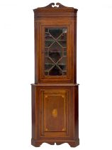 An Edwardian mahogany and inlaid standing corner cupboard.