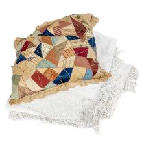 A Victorian crazed patchwork cushion with fine lace frill.