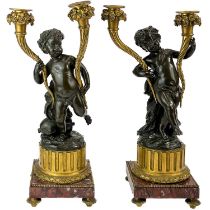 A pair of French bronze and ormolu figural candelabra, after Clodion.