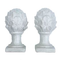 A pair of white ceramic cones of naturalistic form.