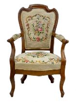 A late 19th century French walnut carved fauteuil.