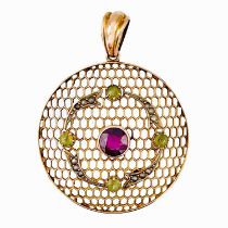 An Edwardian Suffragette 9ct gold pendant set with a pyrope garnet, peridot and seed pearl.