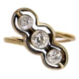 An early 20th century gold diamond set three-stone crossover ring.