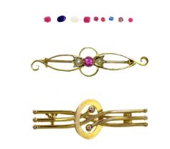 Two 15ct gold brooches and a selection of loose gemstones.
