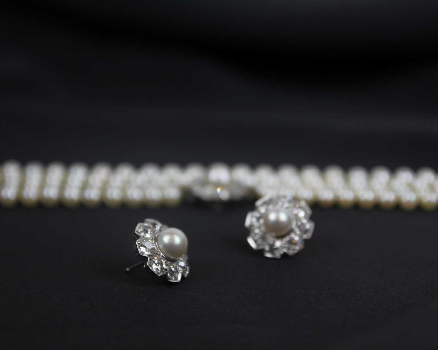 An impressive early 20th century cultured pearl, diamond set, double-row necklace & earrings suite. - Image 3 of 9