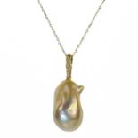 A contemporary 18ct pendant with a suspended large Baroque cultured pearl and with diamond set bale.