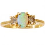 A 14ct white opal and diamond three-stone ring.