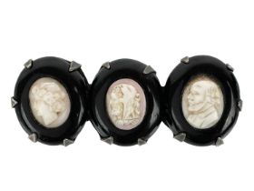 A Victorian triple shell cameo and jet silver mounted brooch.