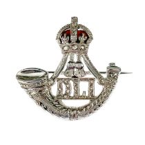 A 9ct white diamond set and red enamel WWII Durham Light Infantry sweetheart brooch.