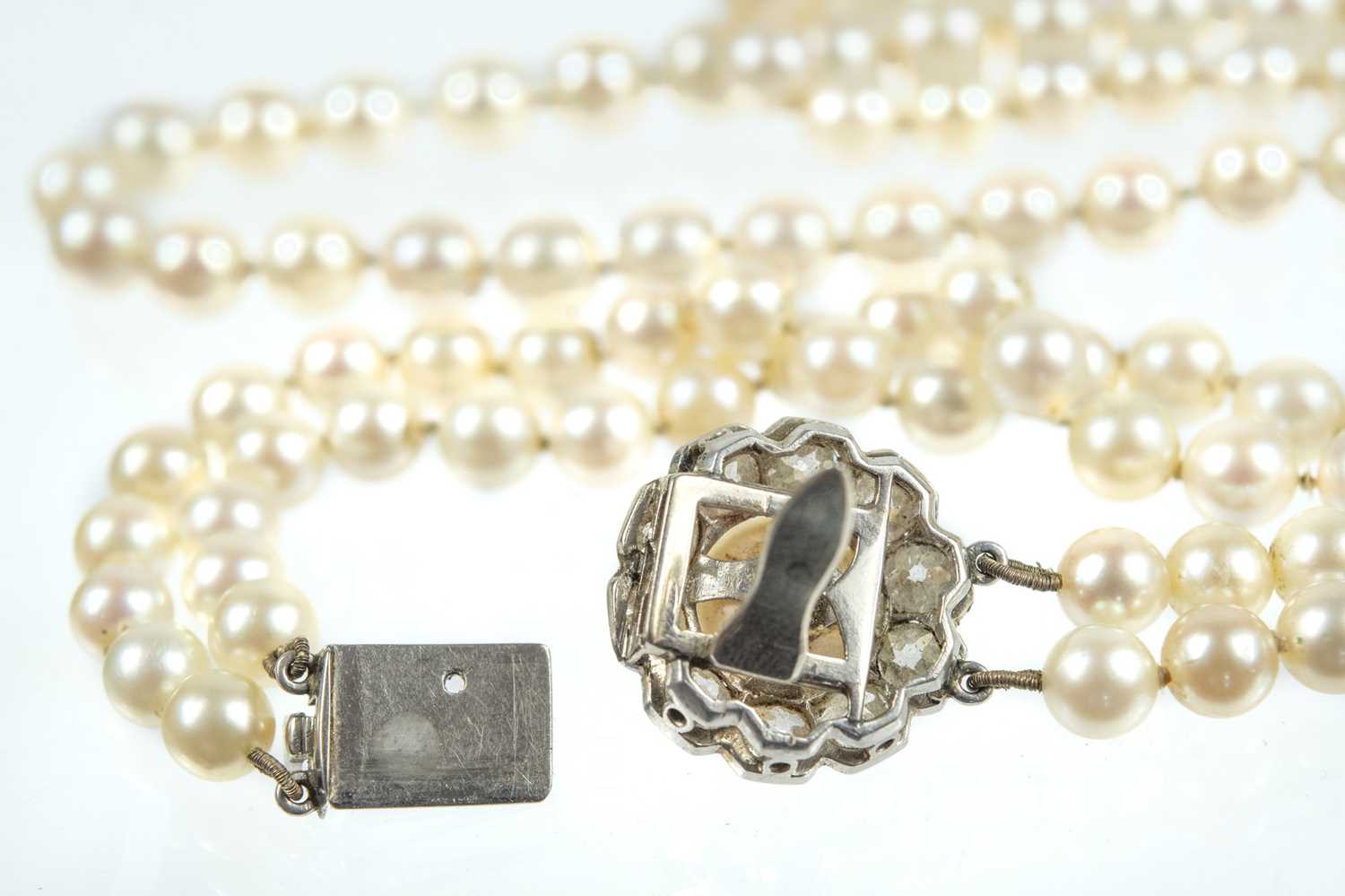 An impressive early 20th century cultured pearl, diamond set, double-row necklace & earrings suite. - Image 8 of 9