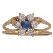 A cluster gem set reversible gold ring.