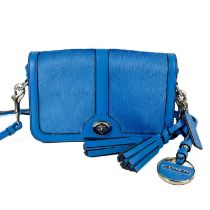 A blue Coach leather and calf hair turn lock crossbody bag.
