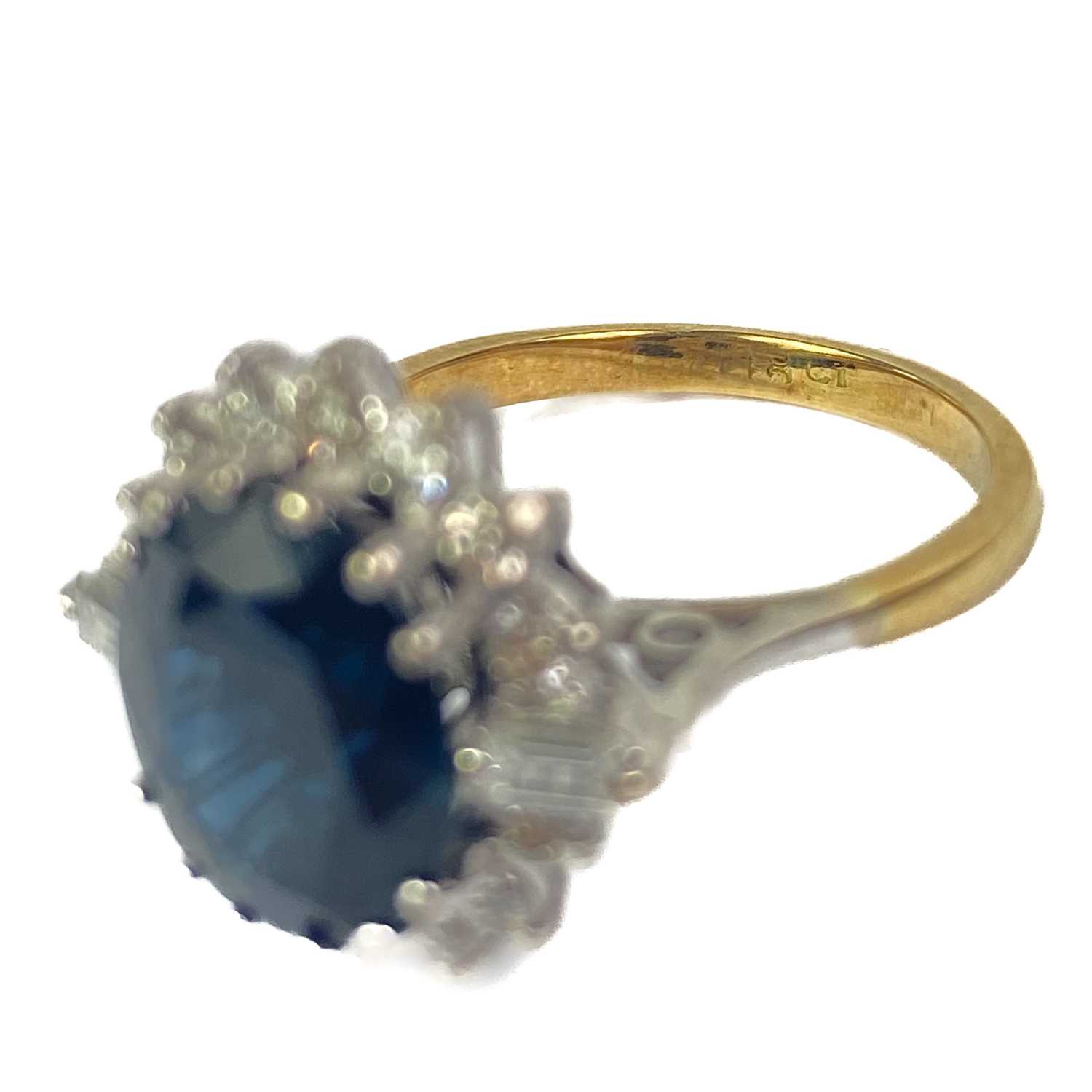 An 18ct oval blue sapphire and diamond cluster ring. - Image 2 of 4