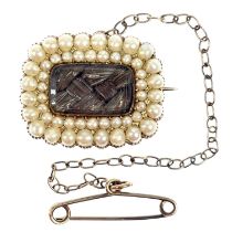 A George IV gold mourning brooch with split seed pearls and a glazed hair panel.