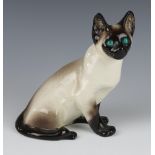 A Jenny Winstanley ceramic figure of a seated Siamese cat with glass eyes no36. 21cm, signed
