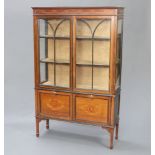 An Edwardian inlaid mahogany display cabinet with moulded cornice, fitted shelves enclosed by