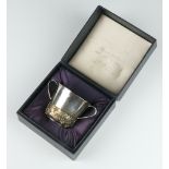 Stuart Devlin, a cast silver and silver gilt commemorative Royal Christening 2 handled porringer