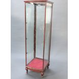 An Edwardian mahogany bow front pedestal shop display cabinet, fitted 3 long shelves, raised on