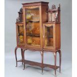 An Edwardian Art Nouveau inlaid mahogany display cabinet, the centre section fitted shelves enclosed