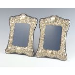 A pair of Victorian style repousse silver photograph frames with scroll decoration, Sheffield