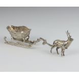 A Continental silver 925 standard model of a deer pulling a sleigh with scroll decoration 15.5cm, 62