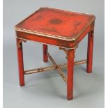 A Regency chinoiserie style square red "lacquered" lamp table on shaped supports with pierced X