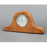 A Smiths car clock, the 7cm dial with Roman numerals marked Smiths P-295.864, contained in an oak